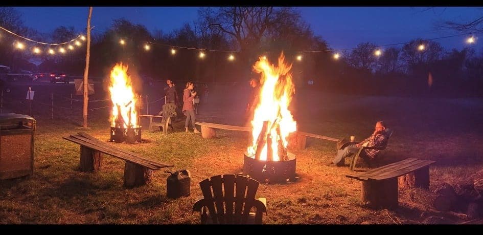 Campfires glowing in the darkness during the Night Maze
